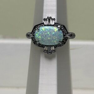 October White Opal on Hematite.  Size 7.